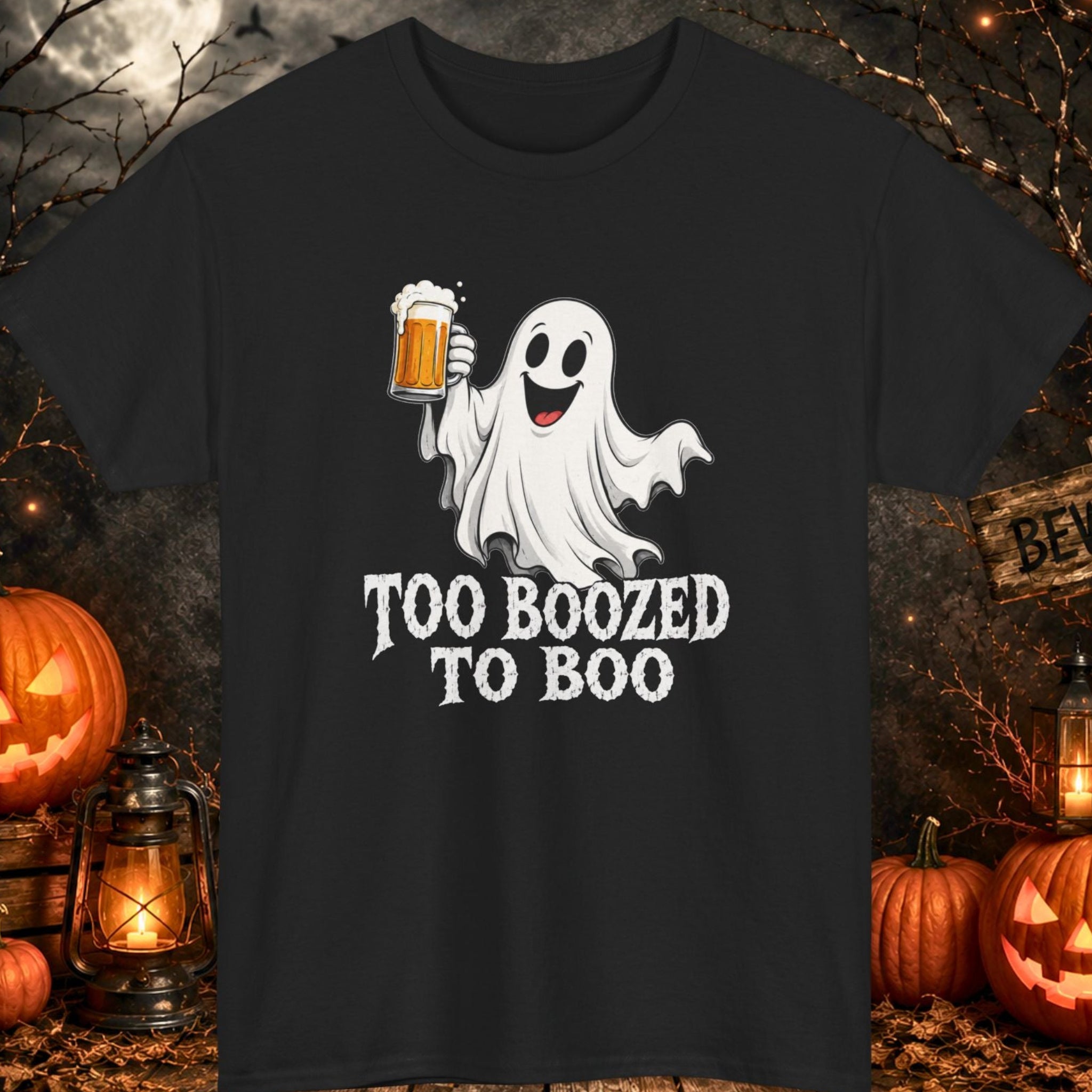 Funny Halloween graphic t-shirt featuring a happy cartoon ghost holding a frosty beer mug with the phrase "Too Boozed to Boo" in distressed white typography on a black shirt, perfect for Halloween parties, brewery visits, beer lovers, bar crawls, and spooky season celebrations.
