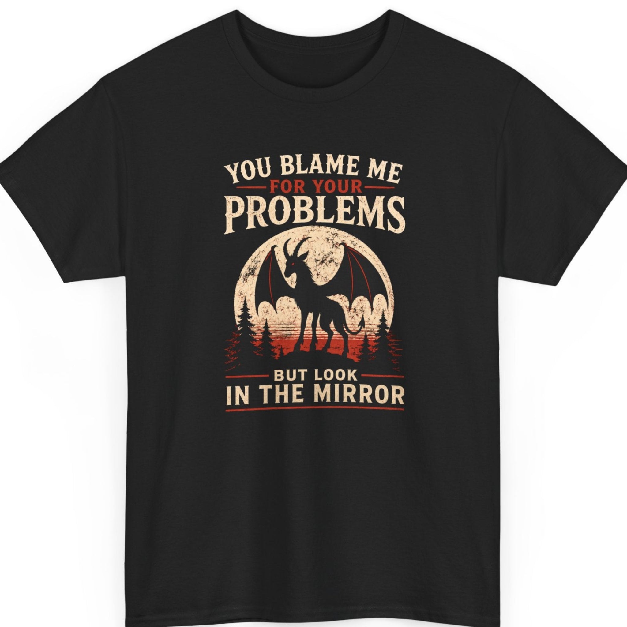 Mayhem Haus Jersey Devil graphic t-shirt on a black shirt featuring a silhouetted Jersey Devil with spread bat wings standing before a distressed full moon above a pine forest, paired with the bold statement "You Blame Me For Your Problems But Look In The Mirror."