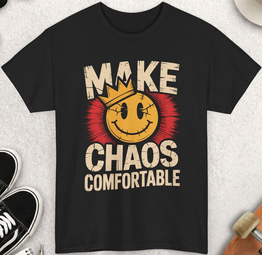 Black t-shirt with 'Make Chaos Comfortable' graphic on a light gray surface with accessories.