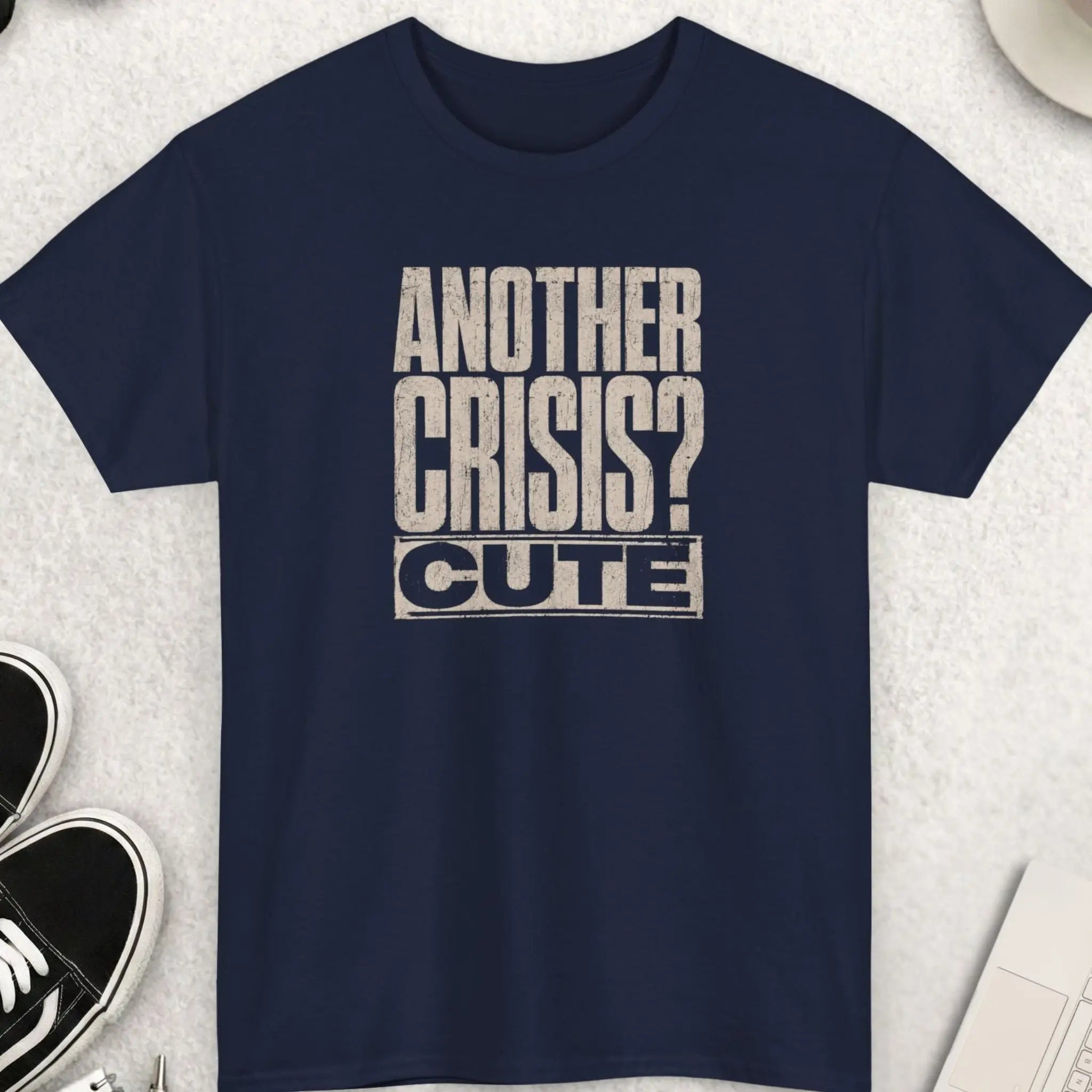 Vintage distressed graphic tee featuring the phrase “Another Crisis? Cute.” in large off-white typography on a navy blue shirt with cynical humor and streetwear styling.