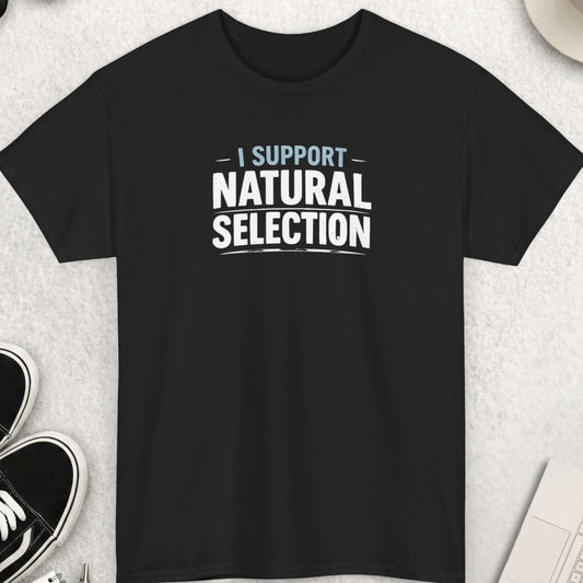 Black t-shirt with 'I Support Natural Selection' text on a light gray surface with shoes, coffee, and sunglasses.