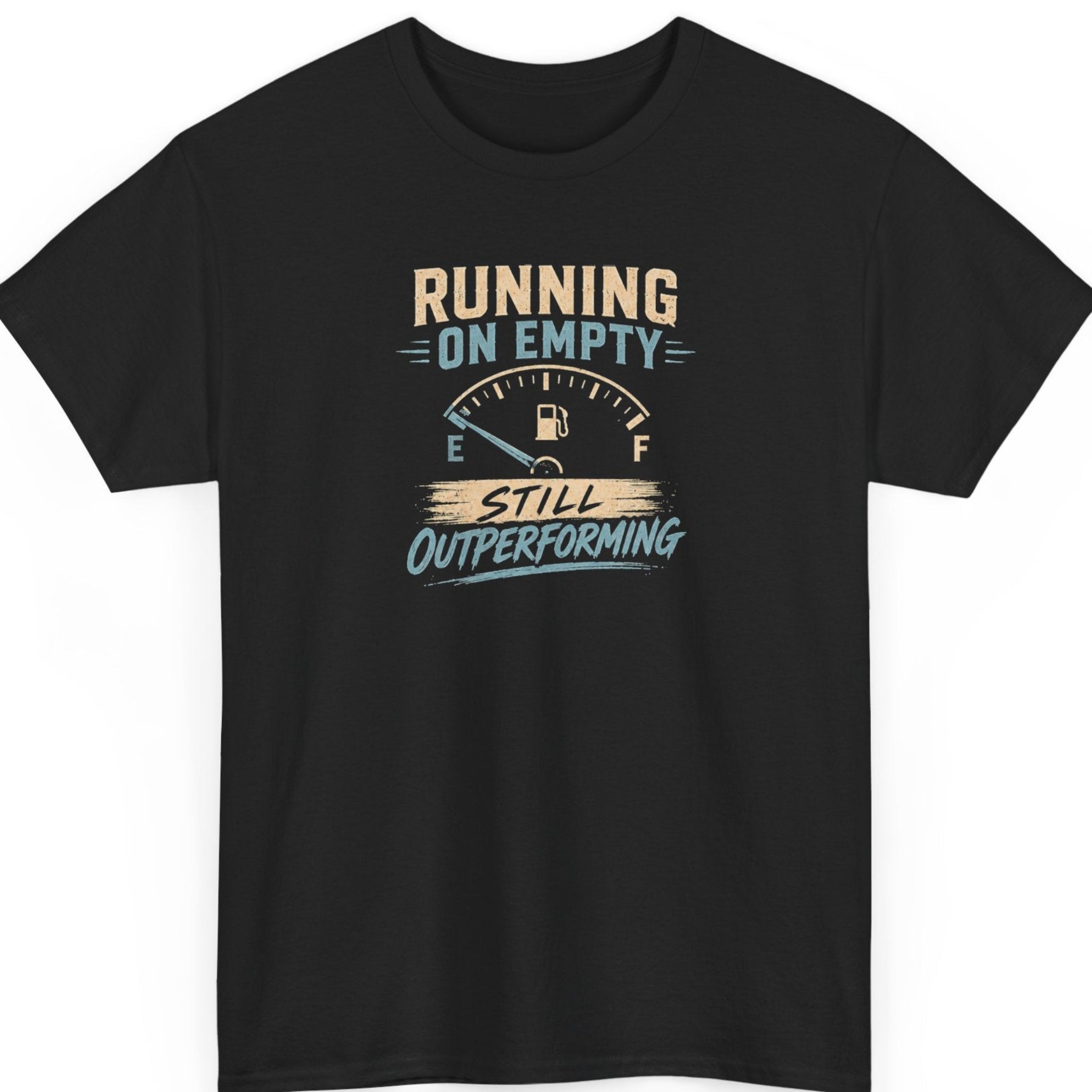 Mayhem Haus motivational graphic t-shirt on a black shirt featuring the phrase "Running on Empty Still Outperforming" with a vintage low fuel gauge in distressed cream and light blue typography.