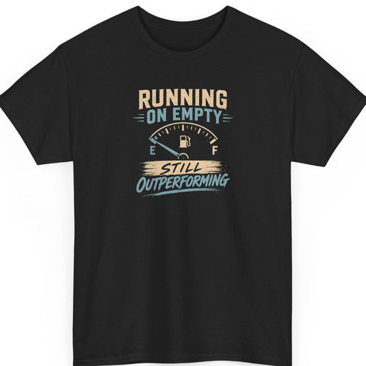 Mayhem Haus motivational graphic t-shirt on a black shirt featuring the phrase "Running on Empty Still Outperforming" with a vintage low fuel gauge in distressed cream and light blue typography.