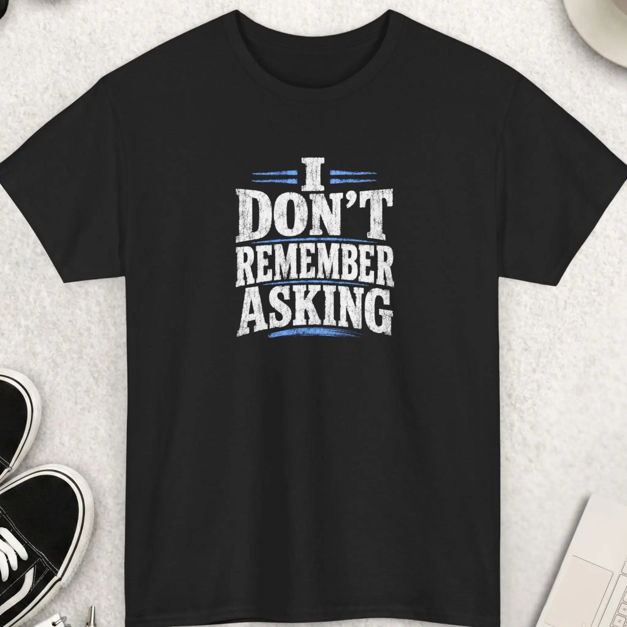 Black distressed graphic t-shirt featuring the phrase “I Don’t Remember Asking” in bold cracked white typography with red accent lines in a sarcastic grunge streetwear design by Mayhem Haus.