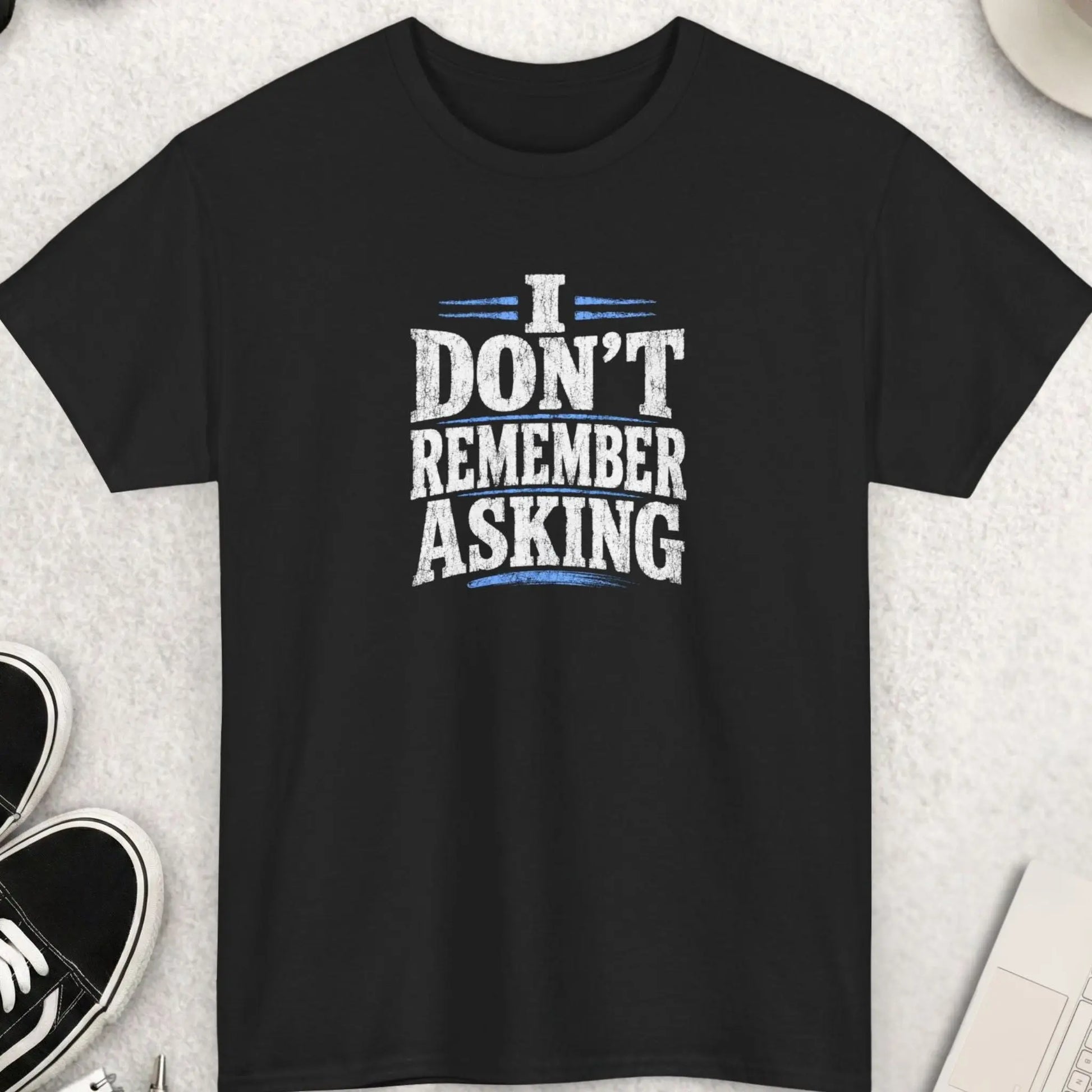 Black distressed graphic t-shirt featuring the phrase “I Don’t Remember Asking” in bold cracked white typography with red accent lines in a sarcastic grunge streetwear design by Mayhem Haus.