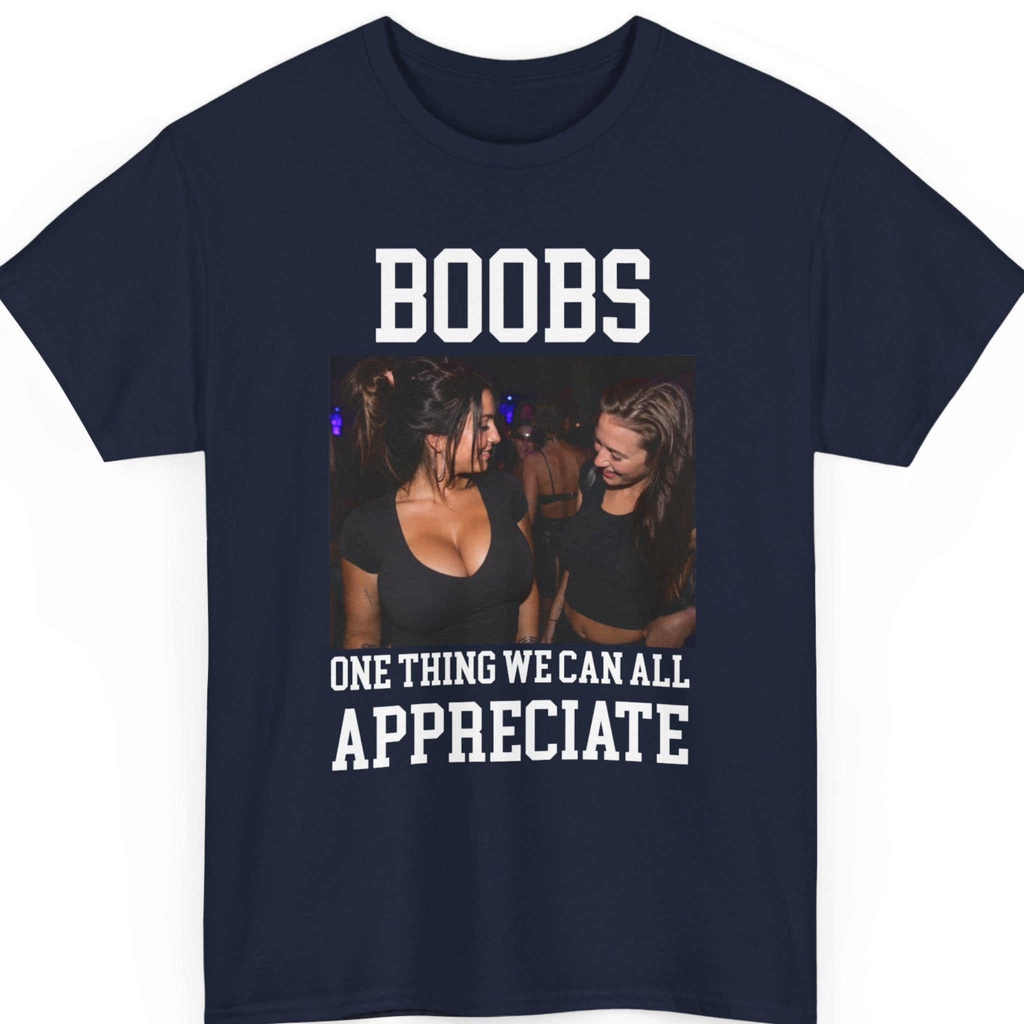 Mayhem Haus humorous graphic tee on a navy blue shirt featuring bold varsity typography reading "Boobs One Thing We Can All Appreciate" with a nightclub-inspired photo.
