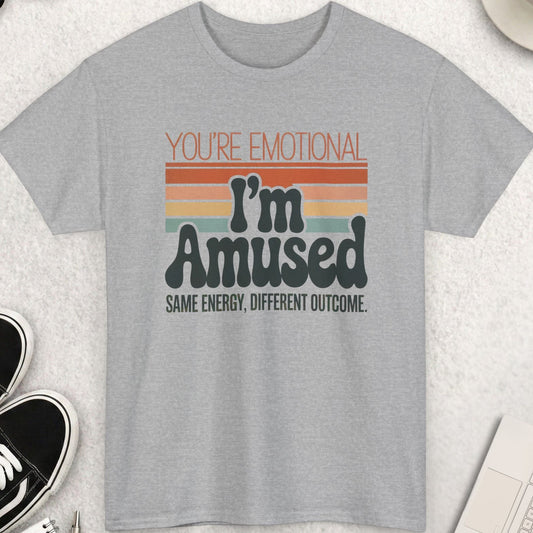 Gray t-shirt with humorous text design on a light surface with accessories.
