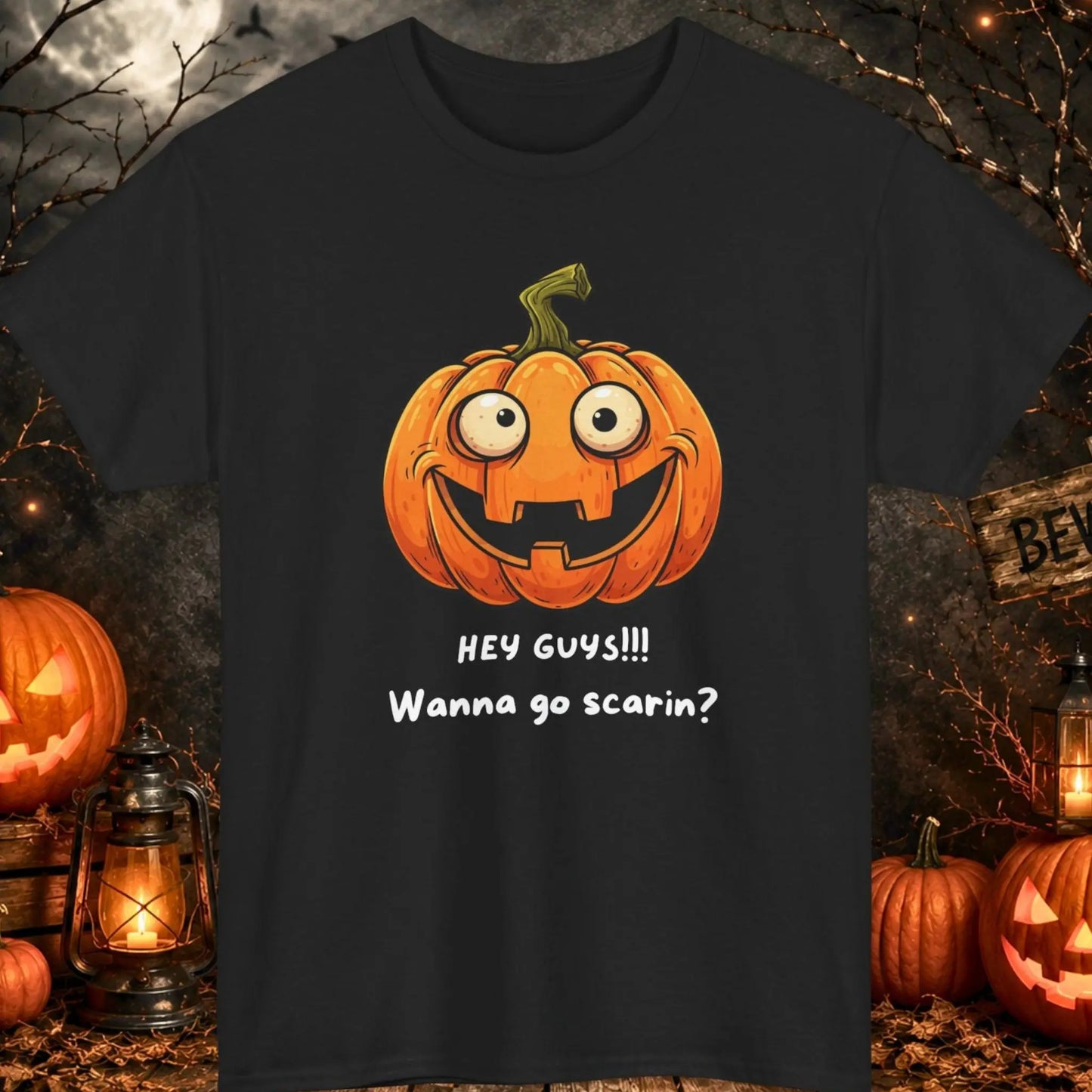 Funny Halloween pumpkin graphic t-shirt featuring a goofy smiling jack-o'-lantern with the phrase "Hey Guys!!! Wanna Go Scarin?" on an orange shirt, cute spooky season apparel for fall festivals, Halloween parties, and pumpkin lovers.