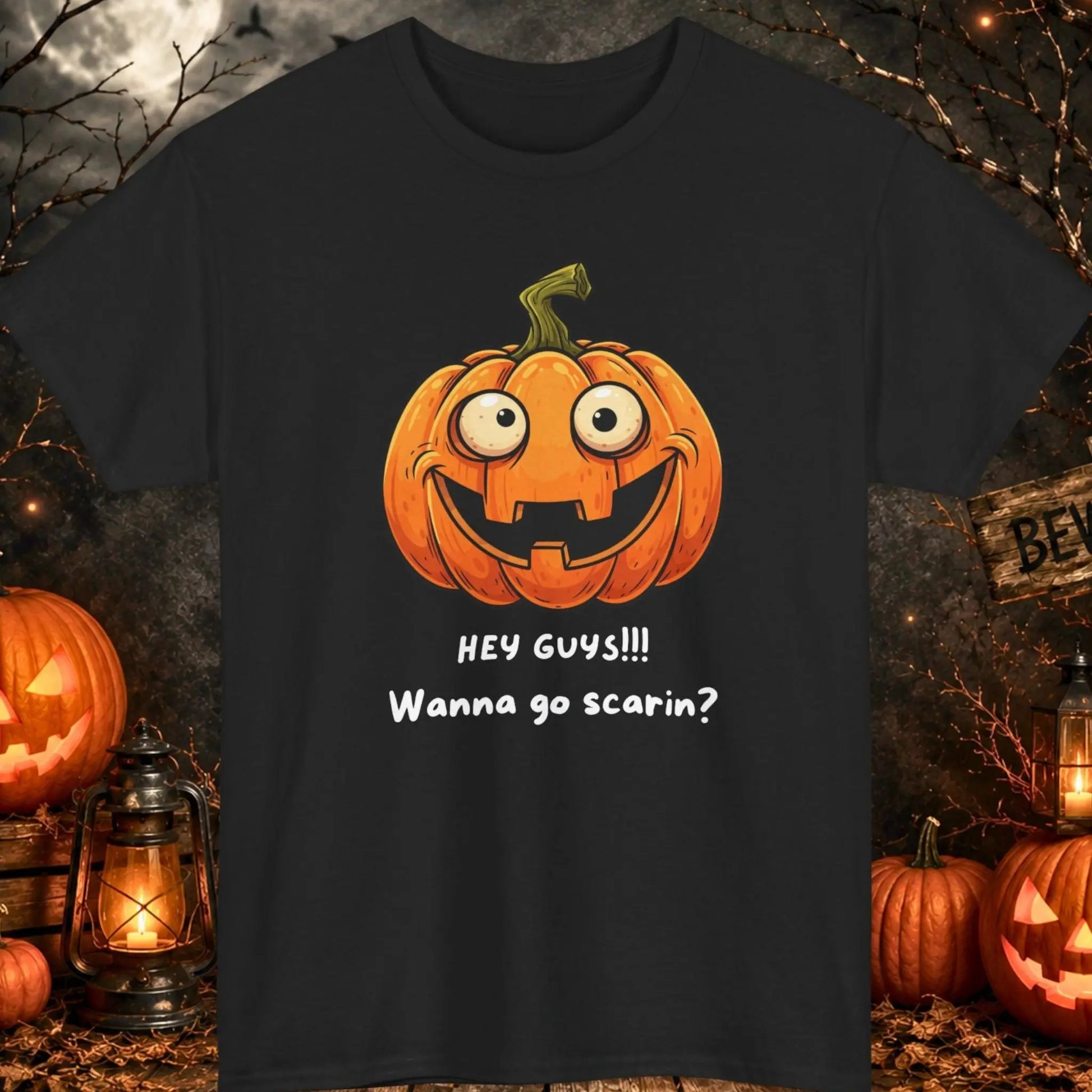 Funny Halloween pumpkin graphic t-shirt featuring a goofy smiling jack-o'-lantern with the phrase "Hey Guys!!! Wanna Go Scarin?" on an orange shirt, cute spooky season apparel for fall festivals, Halloween parties, and pumpkin lovers.