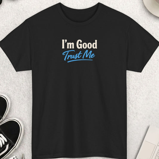 Black t-shirt featuring the phrase "I'm Good Trust Me" in a stylish typography design. The words "I'm Good" appear in large cream-colored distressed lettering, while "Trust Me" is displayed below in bold light blue script with an underline accent. The design blends confidence, humor, and self-assurance with a clean, modern vintage-inspired aesthetic.
