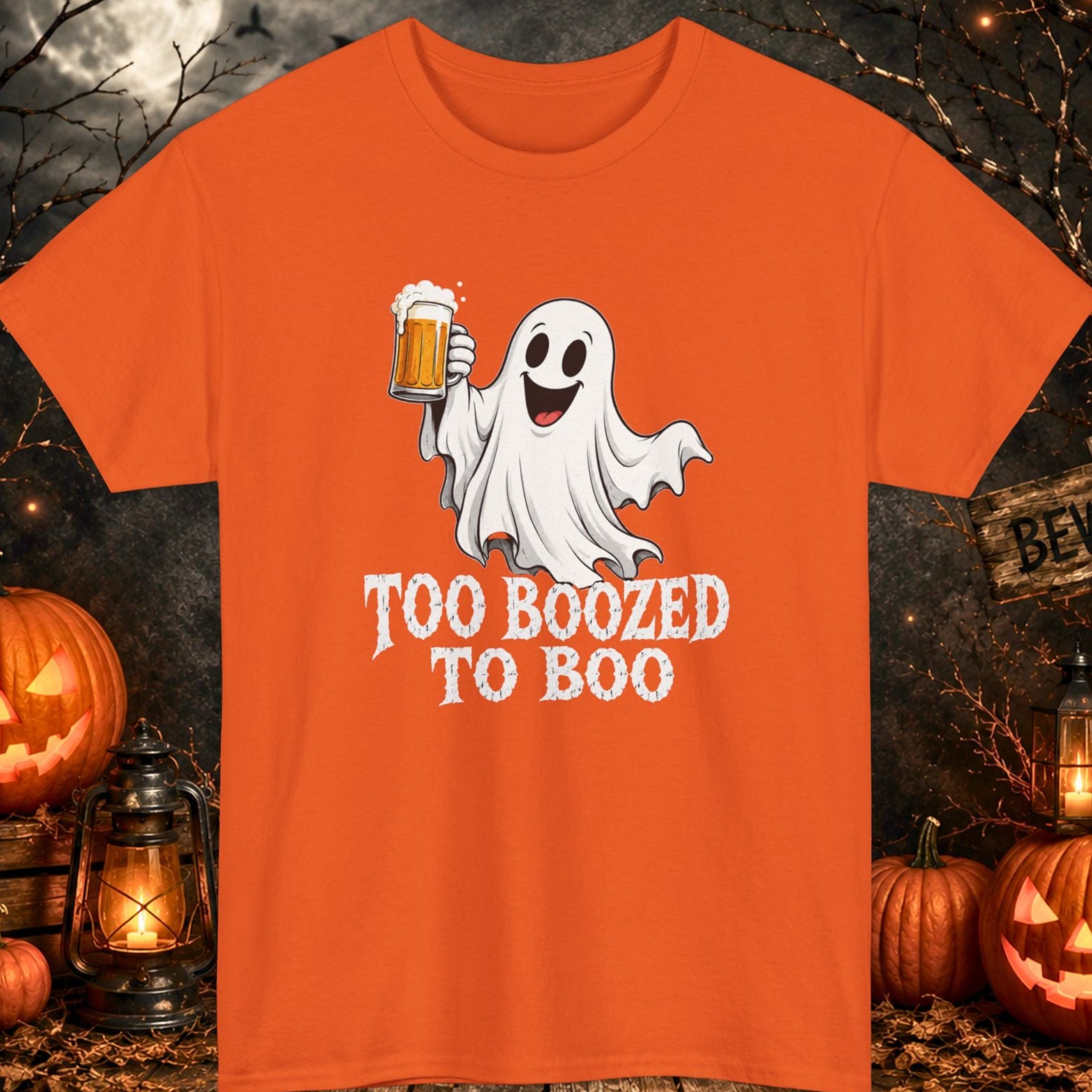 Funny Halloween graphic t-shirt featuring a happy cartoon ghost holding a frosty beer mug with the phrase "Too Boozed to Boo" in distressed white typography on a orange shirt, perfect for Halloween parties, brewery visits, beer lovers, bar crawls, and spooky season celebrations.