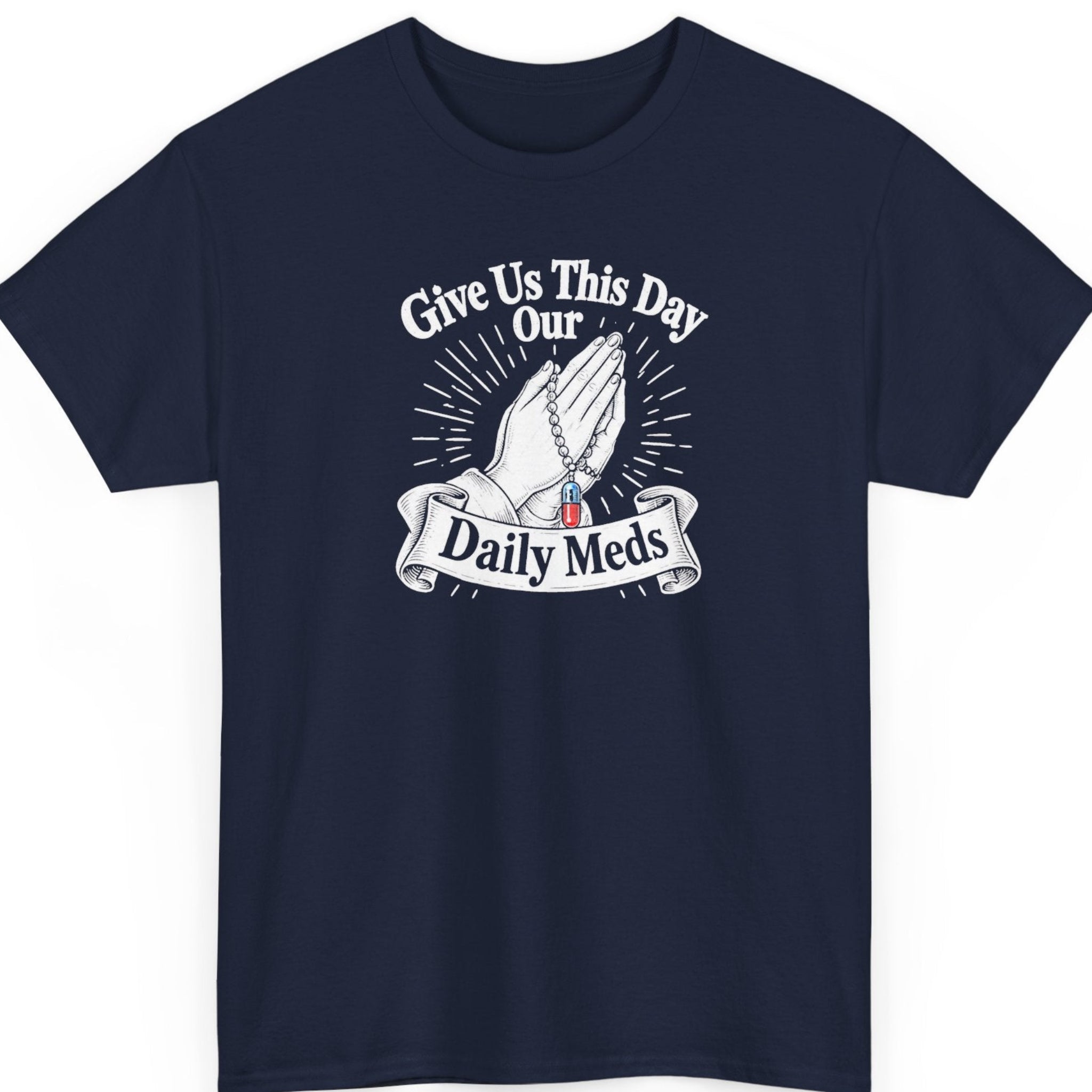 Mayhem Haus “Give Us This Day Our Daily Meds” navy blue t-shirt featuring white illustrated praying hands, a rosary with a red and blue capsule, and vintage religious-inspired typography.