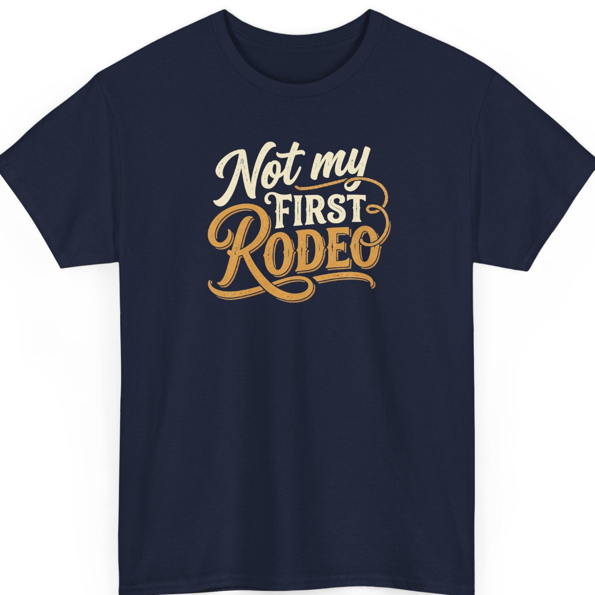 Mayhem Haus “Not My First Rodeo” navy blue t-shirt featuring cream and golden tan Western-style lettering, ornate swashes, vintage script typography, and decorative flourishes.