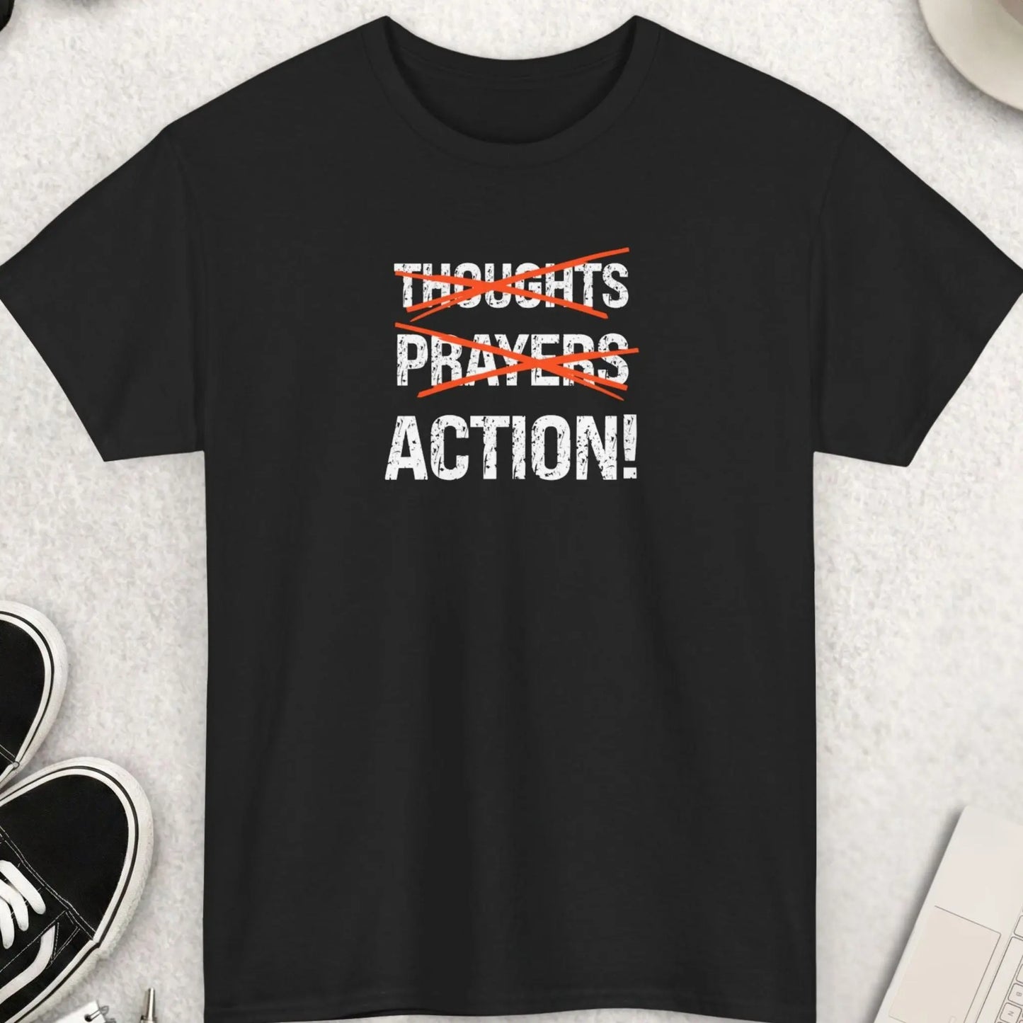 Black t-shirt with bold “Thoughts Prayers Action” graphic, with thoughts and prayers crossed out in red