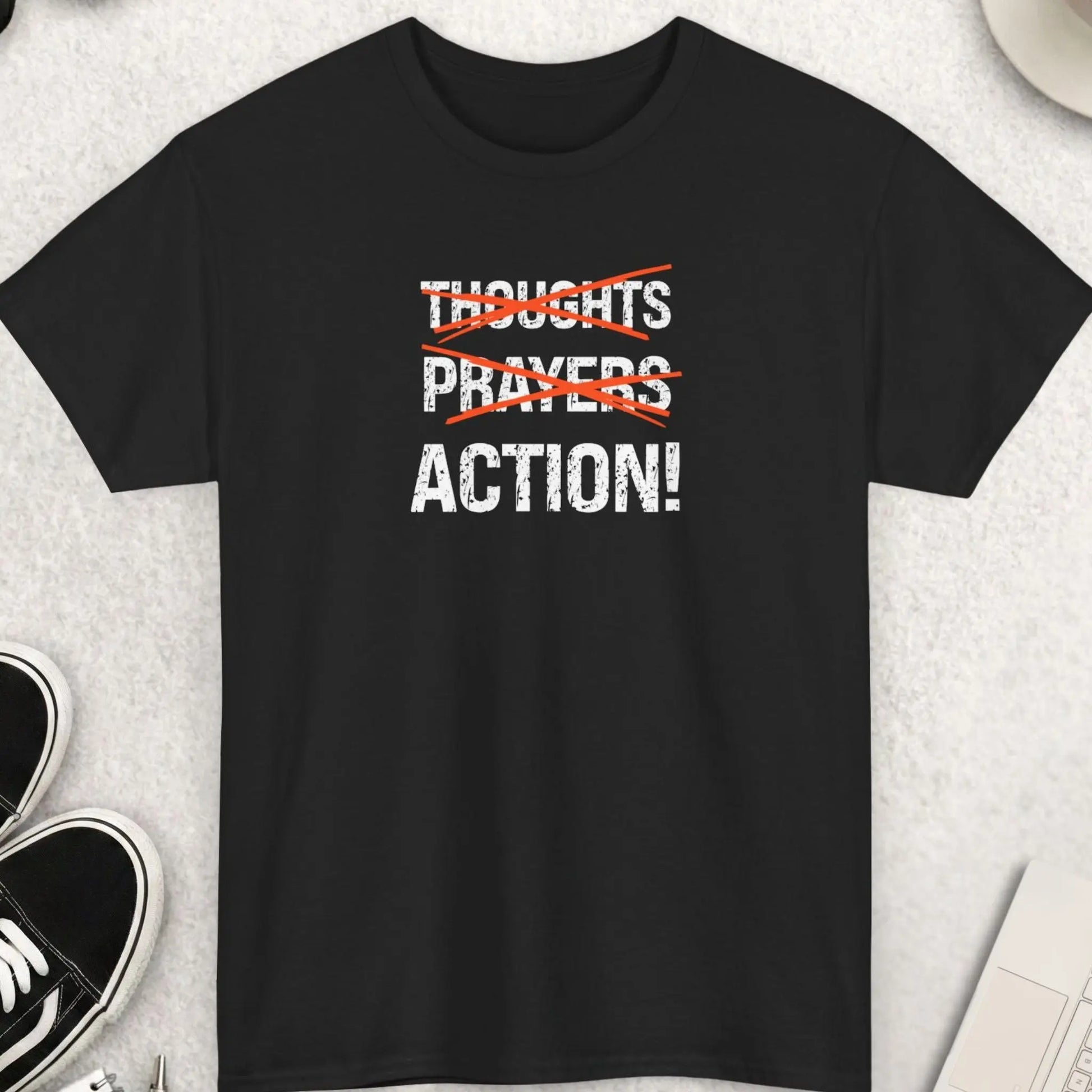 Black t-shirt with bold “Thoughts Prayers Action” graphic, with thoughts and prayers crossed out in red