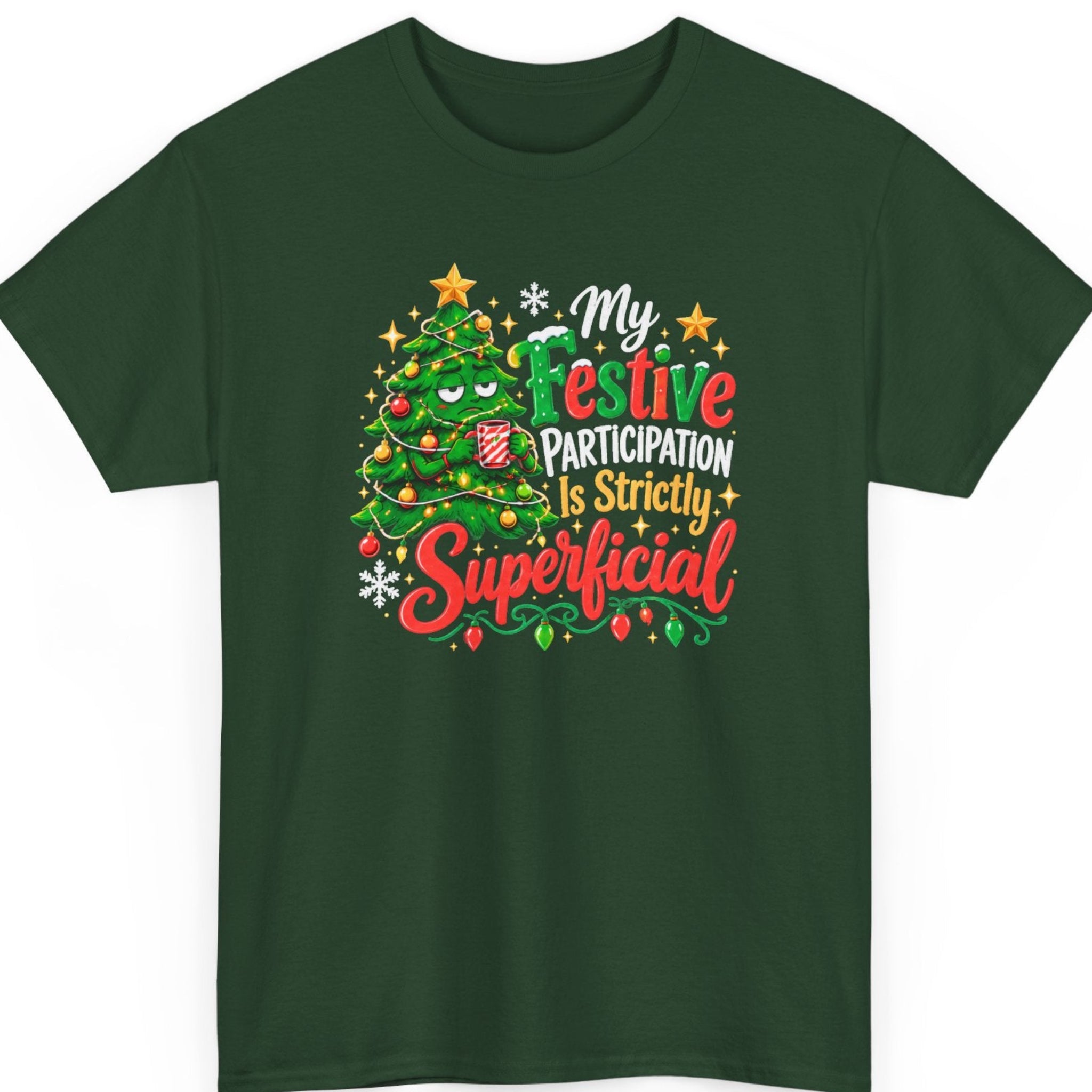Mayhem Haus “My Festive Participation Is Strictly Superficial” forest green t-shirt featuring an unimpressed cartoon Christmas tree wearing ornaments and string lights while holding a striped holiday mug, alongside bold red, green, white, and gold typography with snowflakes and stars.