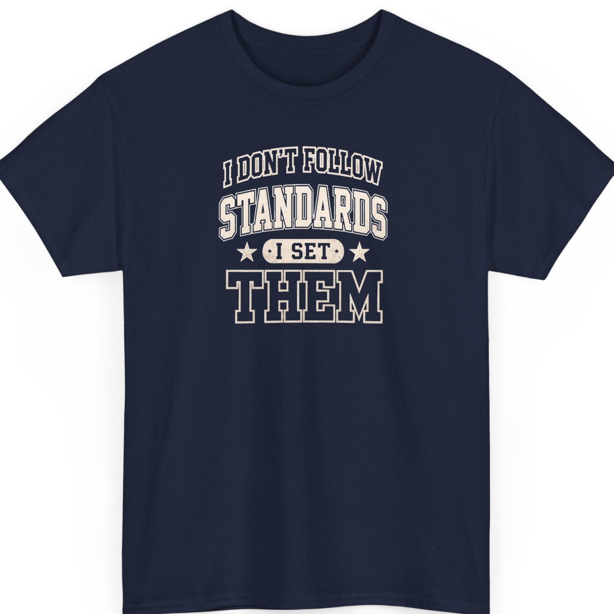 Mayhem Haus statement graphic tee on a navy blue shirt featuring vintage varsity typography with the quote "I Don't Follow Standards I Set Them" in distressed cream lettering.