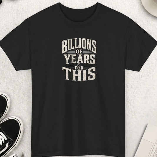 Billions of Years for This" vintage distressed sunburst radial graphic t-shirt on a black background. Bold cream arched serif typography surrounding a central globe icon with radiating lines in a Victorian woodblock print style. Funny science evolution nihilist sarcastic dark humor statement tee.