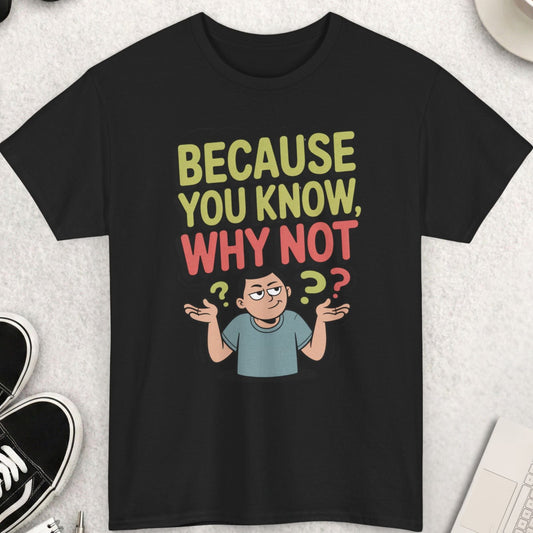 Black t-shirt with colorful text and graphic on a light gray surface with accessories.