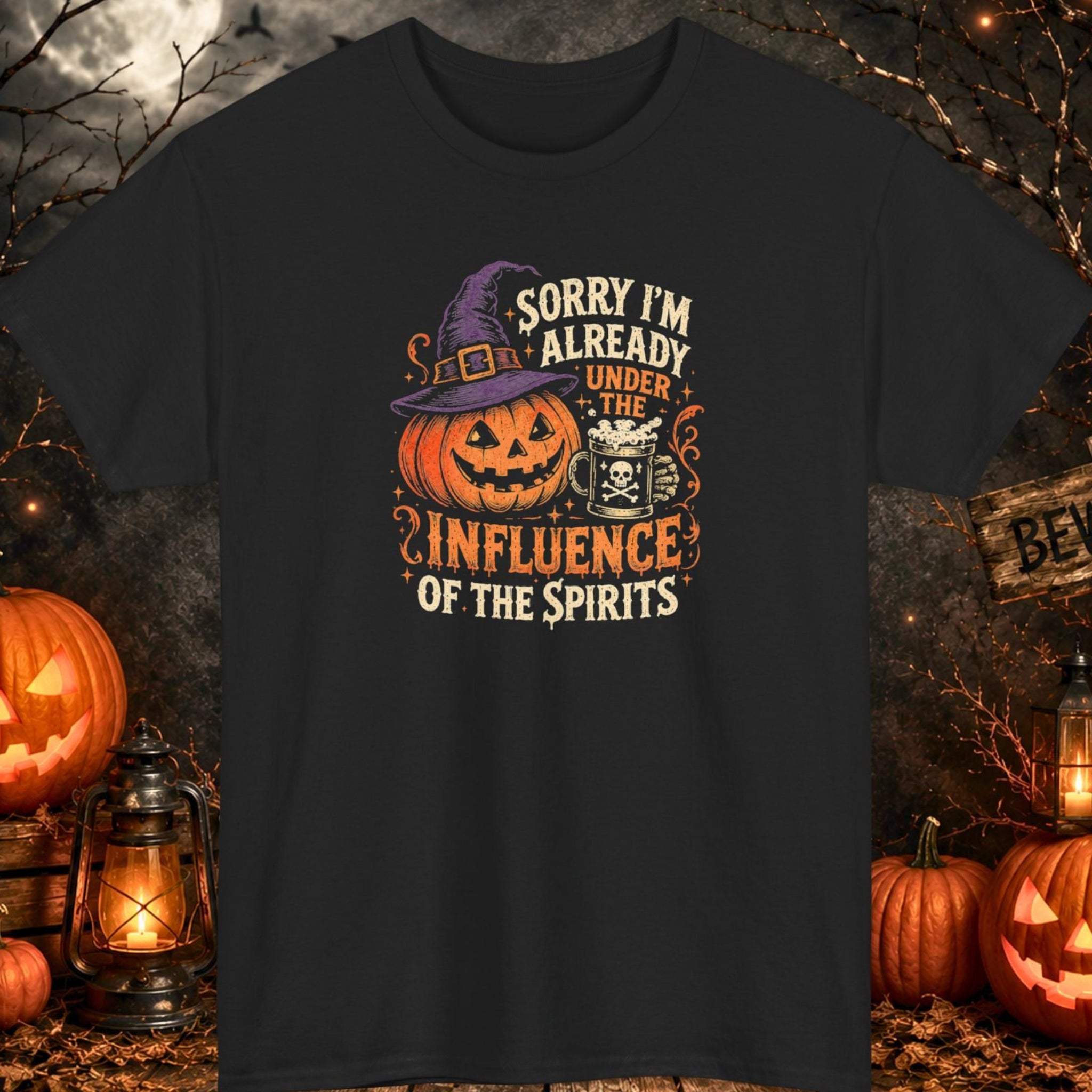 Mayhem Haus black Halloween T-shirt featuring a smiling jack-o'-lantern wearing a purple witch hat beside a frothy mug decorated with a skull and crossbones. The design includes the phrase "Sorry I'm Already Under the Influence of the Spirits" in distressed orange and cream vintage typography.