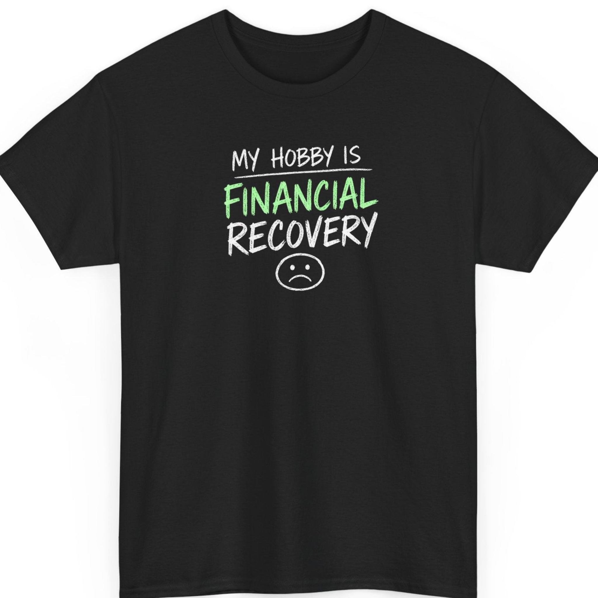 Mayhem Haus "My Hobby Is Financial Recovery" graphic t-shirt on a black shirt featuring distressed white and green typography with a minimalist sad face illustration in a clean stacked design.