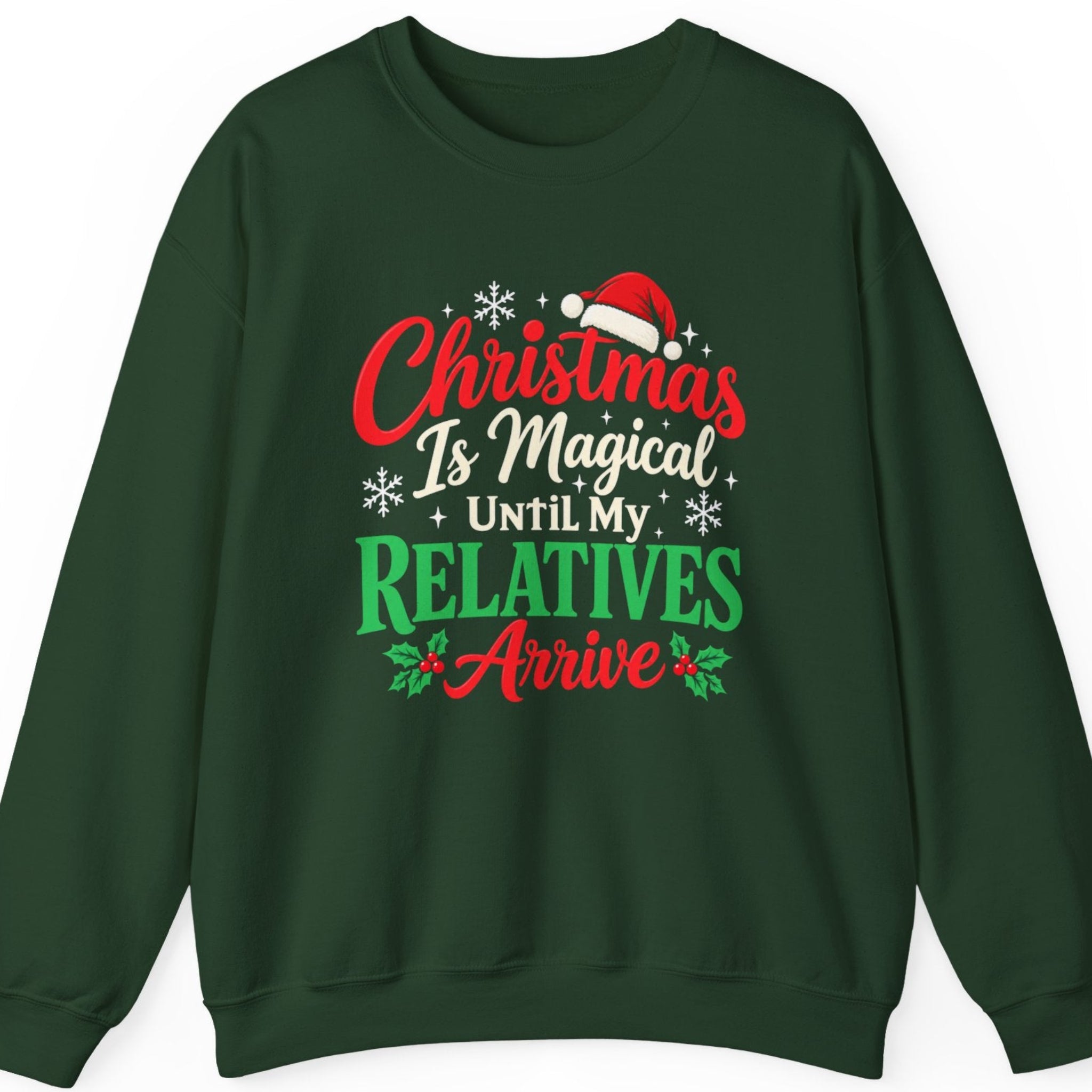 Mayhem Haus “Christmas Is Magical Until My Relatives Arrive” forest green sweatshirt featuring festive distressed typography in red, cream, and bright green, decorated with a red Santa hat, white snowflakes, sparkling accents, and holly leaves with red berries. The humorous Christmas design celebrates holiday family chaos with a sarcastic twist.