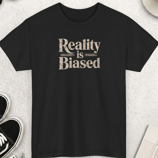 Black t-shirt with distressed bold typography reading “Reality Is Biased” in large vintage-style lettering