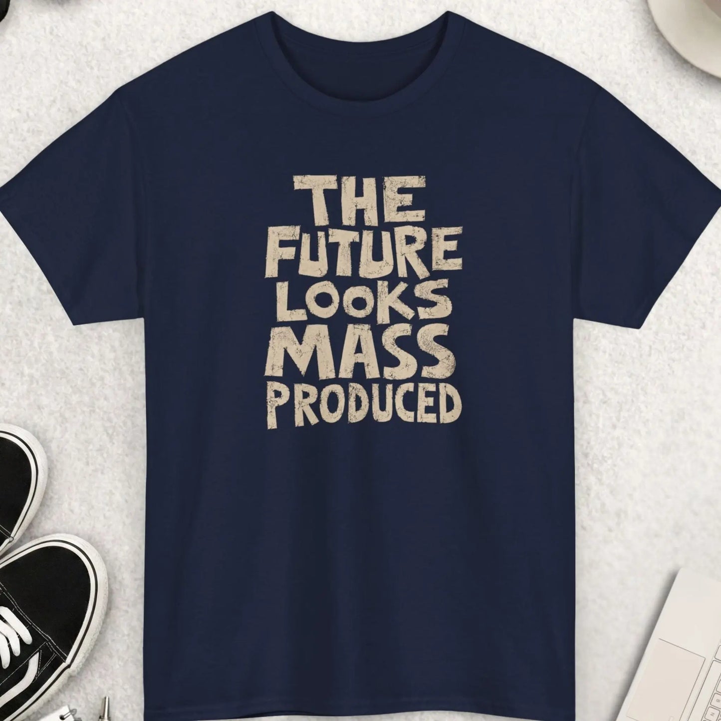 Minimalist grunge graphic tee featuring the phrase “The Future Looks Mass Produced” in distressed cream typography on a navy blue shirt with anti-conformity streetwear vibe.