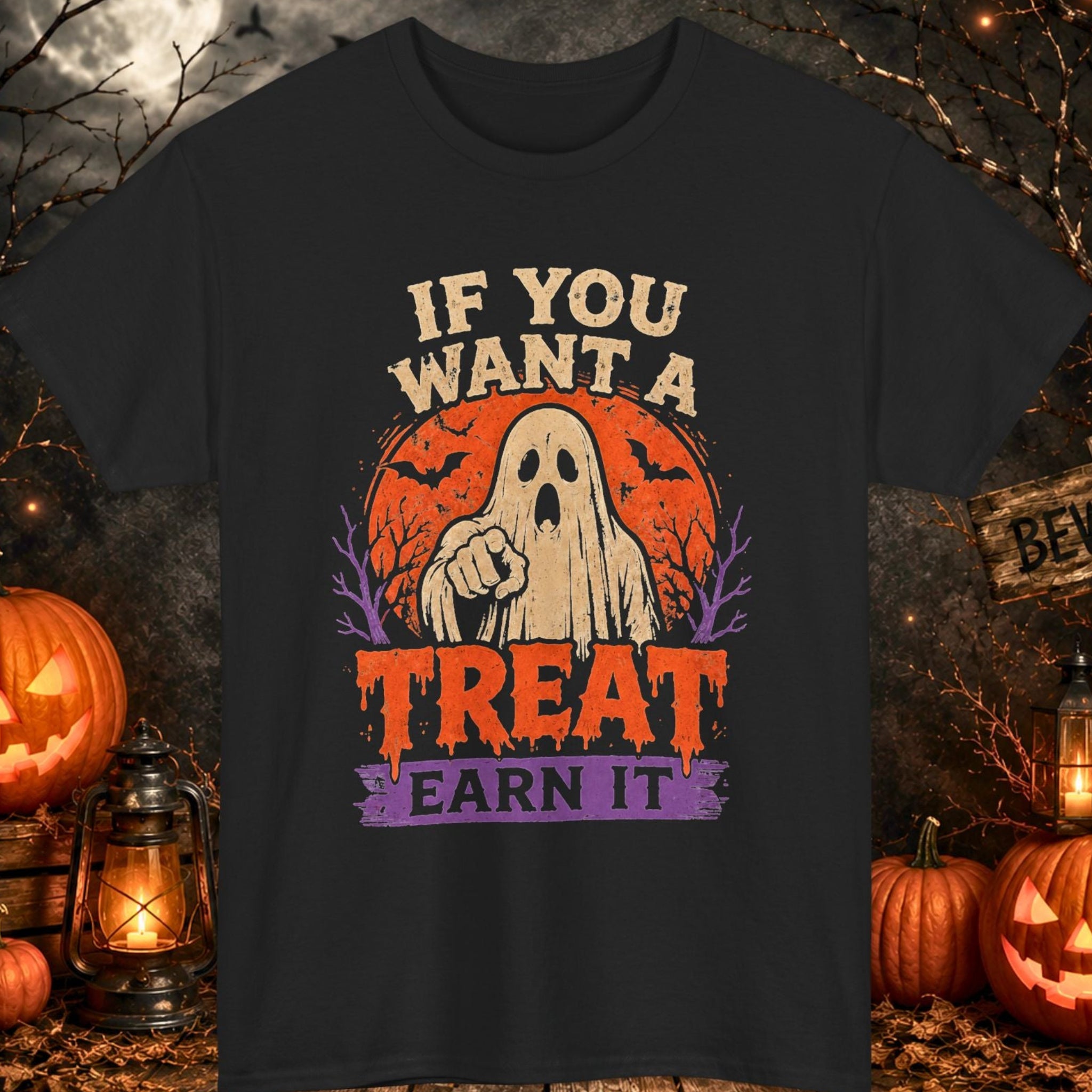 Mayhem Haus black Halloween T-shirt featuring a distressed ghost pointing toward the viewer in front of an orange moon with purple trees and the phrase, "If You Want a Treat Earn It," displayed in vintage cream, orange, and purple typography.