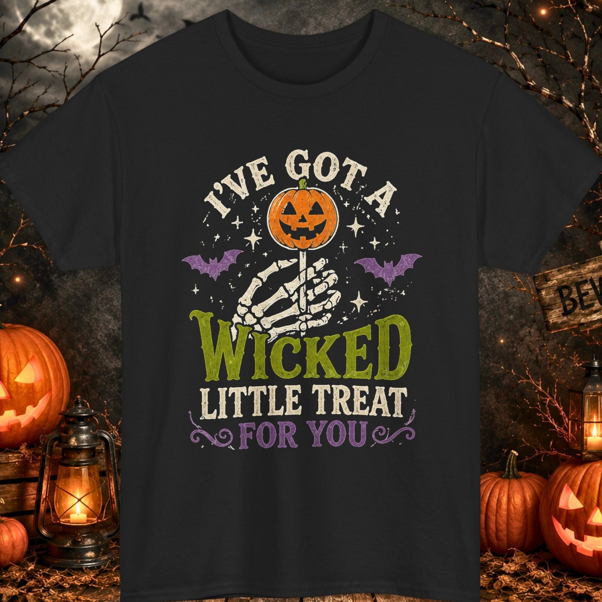 Mayhem Haus black Halloween T-shirt featuring a skeleton hand holding a pumpkin-shaped lollipop surrounded by bats and stars with the phrase, "I've Got a Wicked Little Treat for You," in distressed vintage lettering.