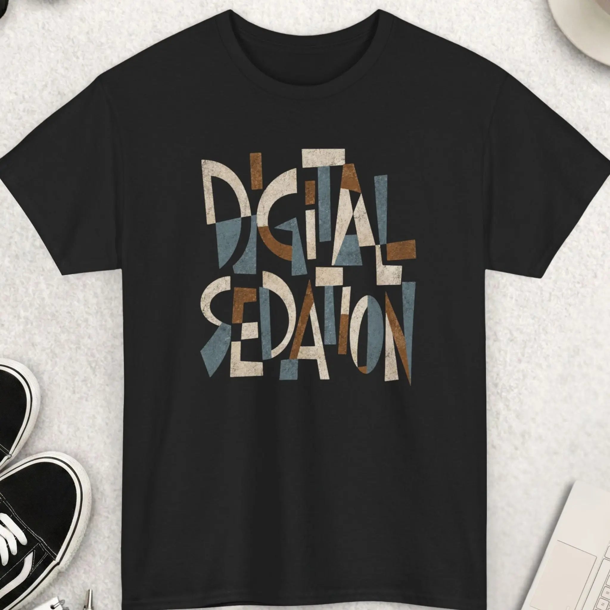 Black t-shirt featuring abstract Cubism-style typography reading “Digital Sedation” in distressed earth-tone geometric lettering.