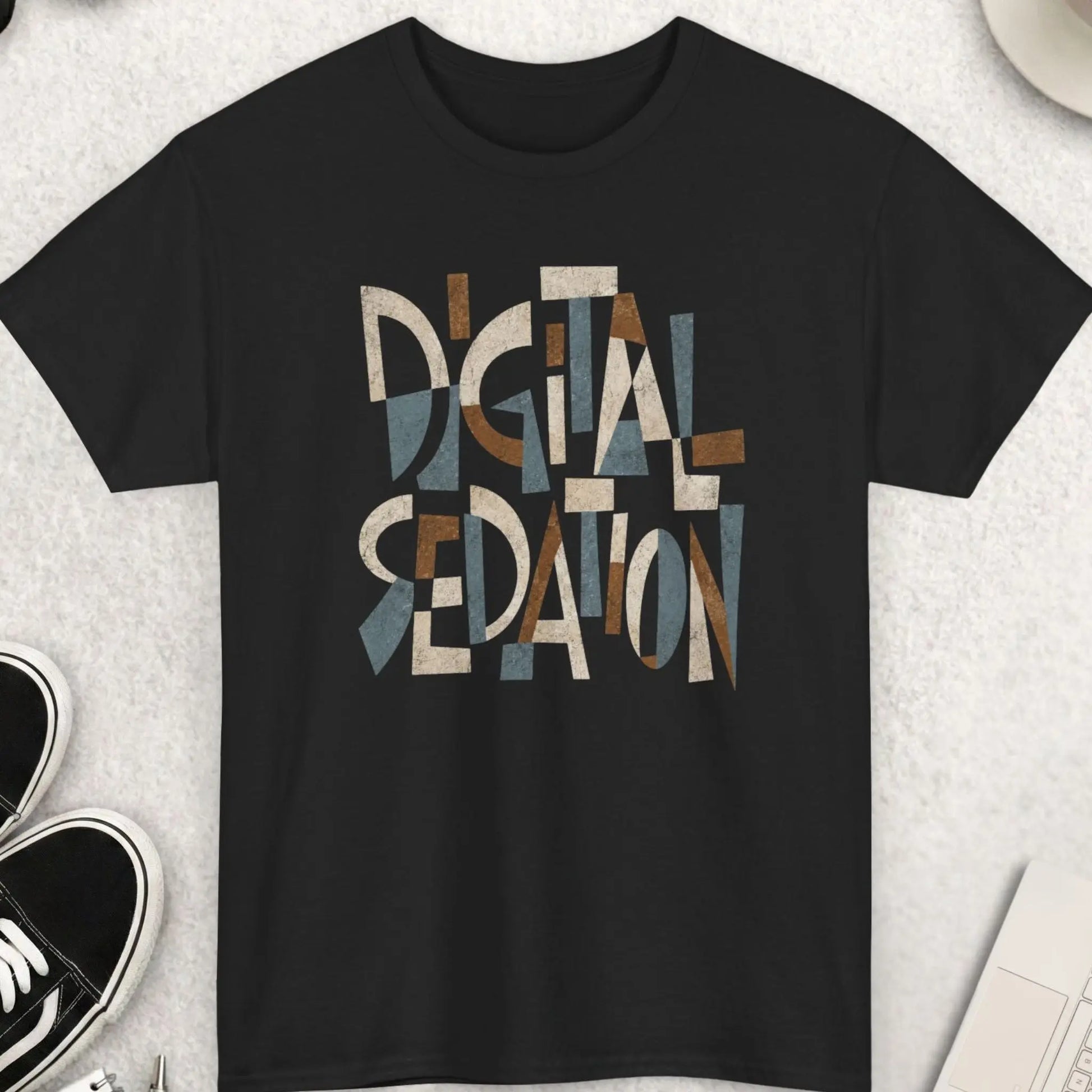 Black t-shirt featuring abstract Cubism-style typography reading “Digital Sedation” in distressed earth-tone geometric lettering.