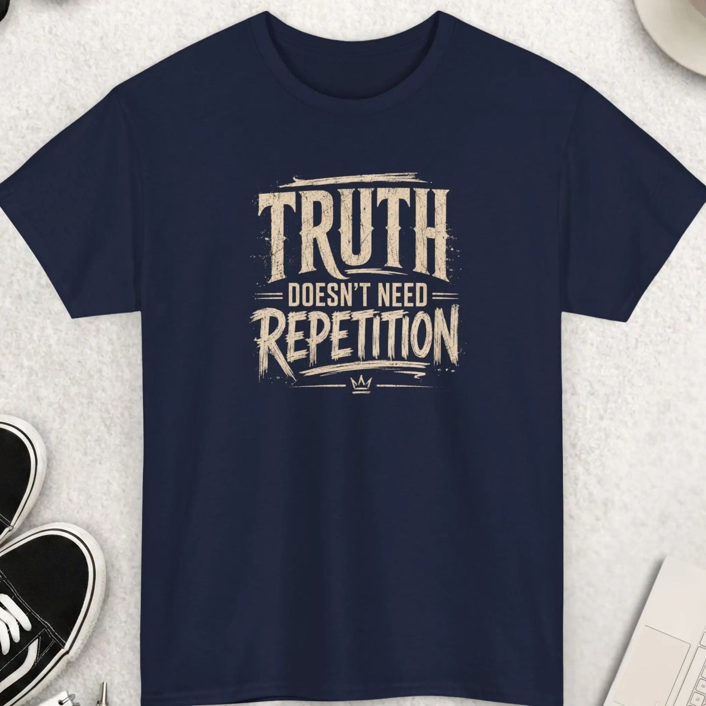 Truth Doesn't Need Repetition vintage distressed graphic t-shirt featuring aged cream typography on a navy blue shirt with worn print texture, bold statement message, and classic retro styling.