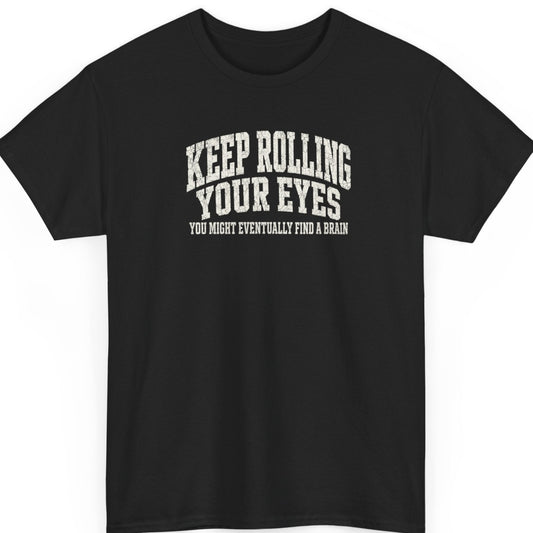 Mayhem Haus "Keep Rolling Your Eyes, You Might Eventually Find a Brain" graphic t-shirt on a black shirt featuring distressed vintage white typography in a bold stacked layout.