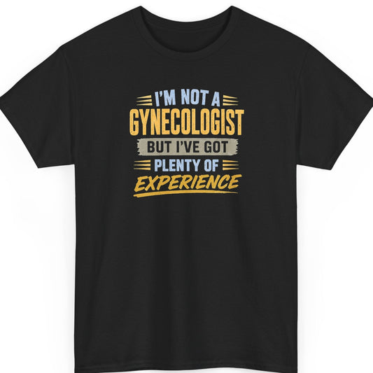 Mayhem Haus funny graphic t-shirt on a black shirt featuring the phrase "I'm Not a Gynecologist But I've Got Plenty of Experience" in distressed blue, gold, gray, and white typography.