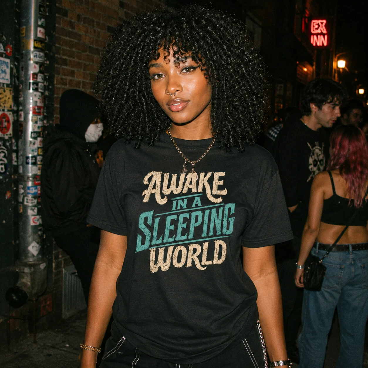 Mayhem Haus Awake in a Sleeping World T-Shirt on a person with curly hair