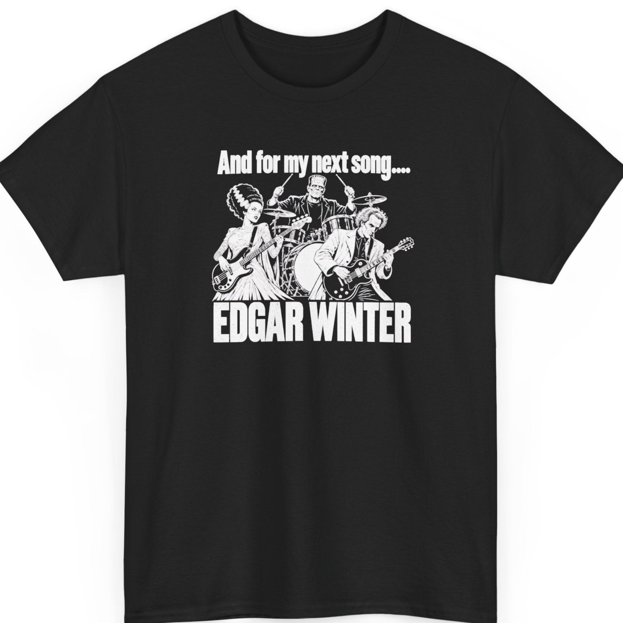 Mayhem Haus “And for My Next Song Edgar Winter” black t-shirt featuring a black-and-white cartoon of Dr. Frankenstein playing guitar, Frankenstein’s monster on drums, and the Bride of Frankenstein playing bass, with bold concert-style lettering.