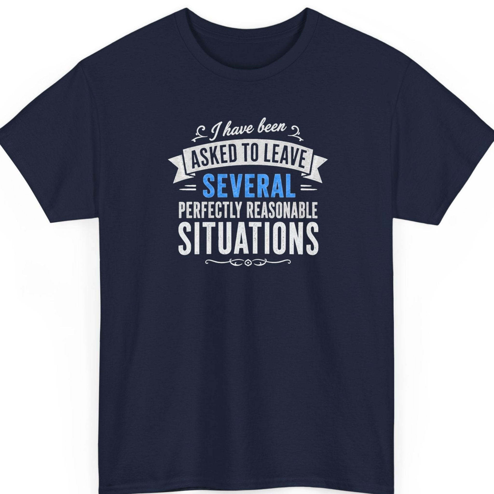 Mayhem Haus funny statement t-shirt on a navy blue tee featuring vintage-inspired typography displaying the phrase, “I Have Been Asked to Leave Several Perfectly Reasonable Situations,” accented with decorative banner elements and blue lettering.