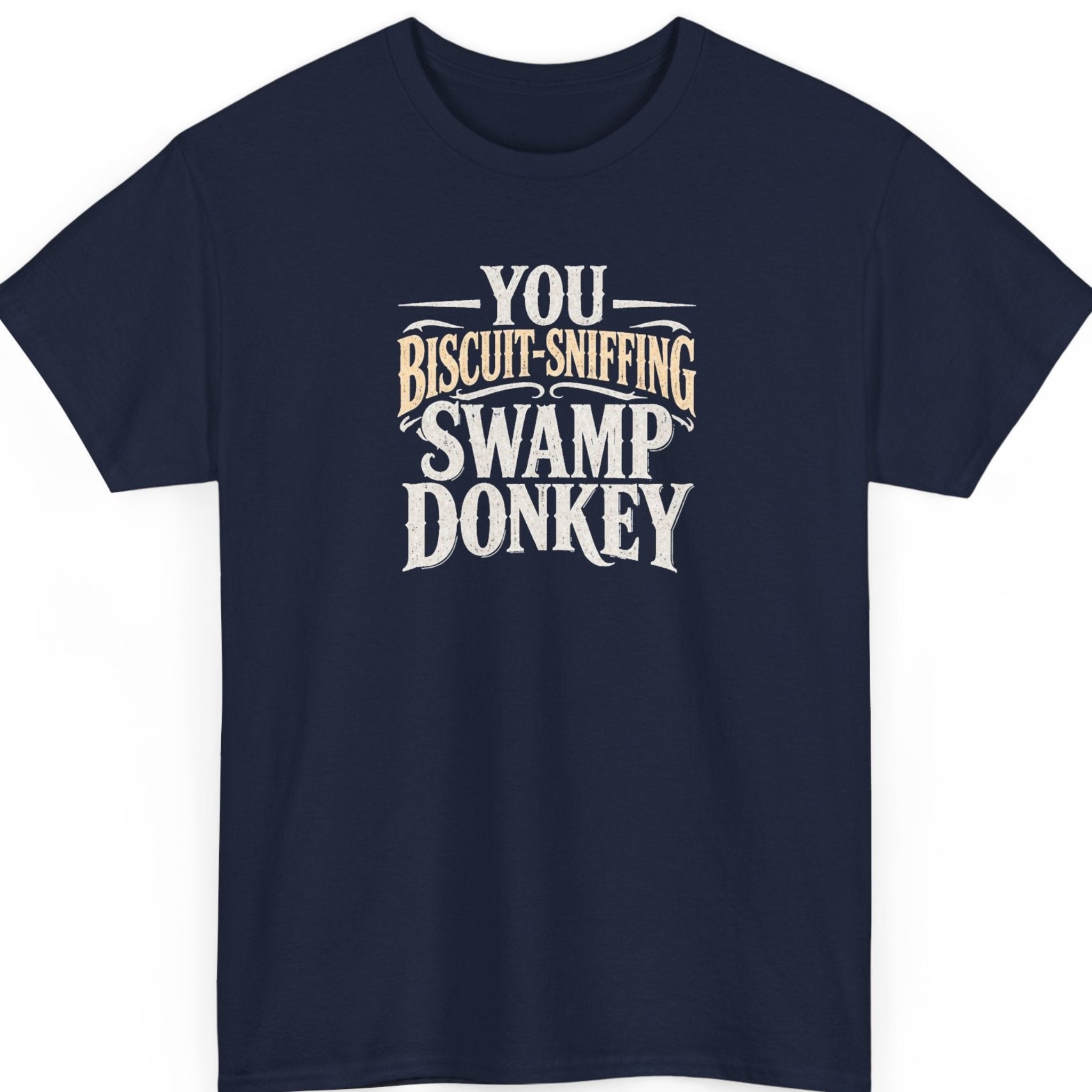 Mayhem Haus “You Biscuit-Sniffing Swamp Donkey” navy blue t-shirt featuring distressed cream and tan vintage Western lettering in a bold stacked layout.