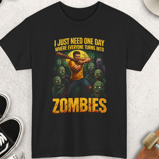 Black t-shirt with a graphic design featuring text and zombies, placed on a light gray surface with accessories around.