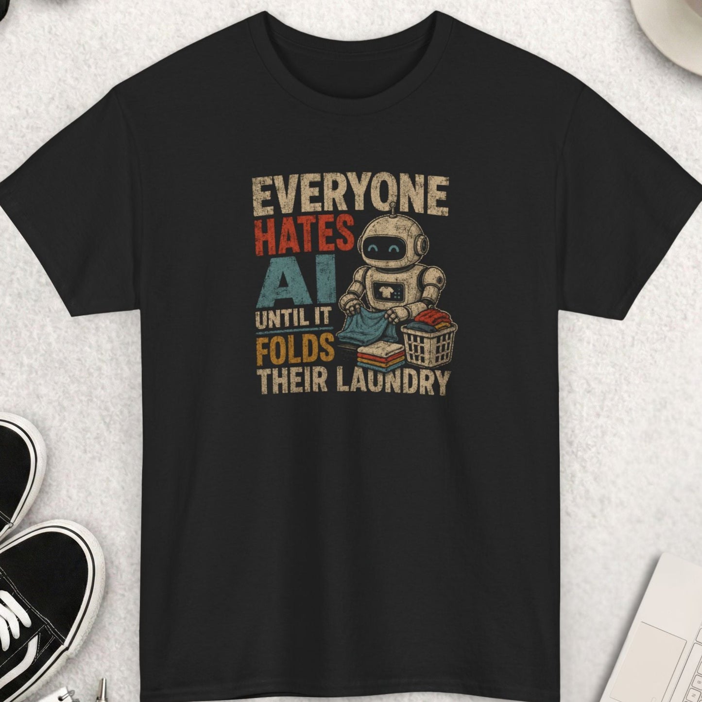Everyone Hates AI Until It Folds Their Laundry funny robot graphic t-shirt featuring vintage distressed typography and cartoon robot folding clothes on black shirt