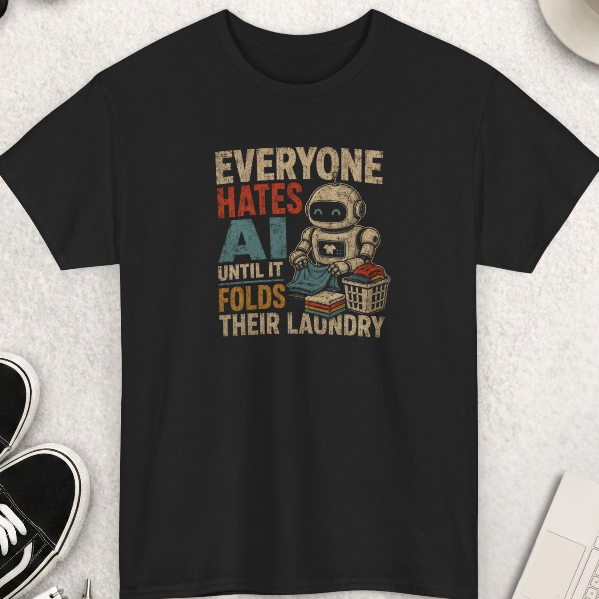 Everyone Hates AI Until It Folds Their Laundry funny robot graphic t-shirt featuring vintage distressed typography and cartoon robot folding clothes on black shirt
