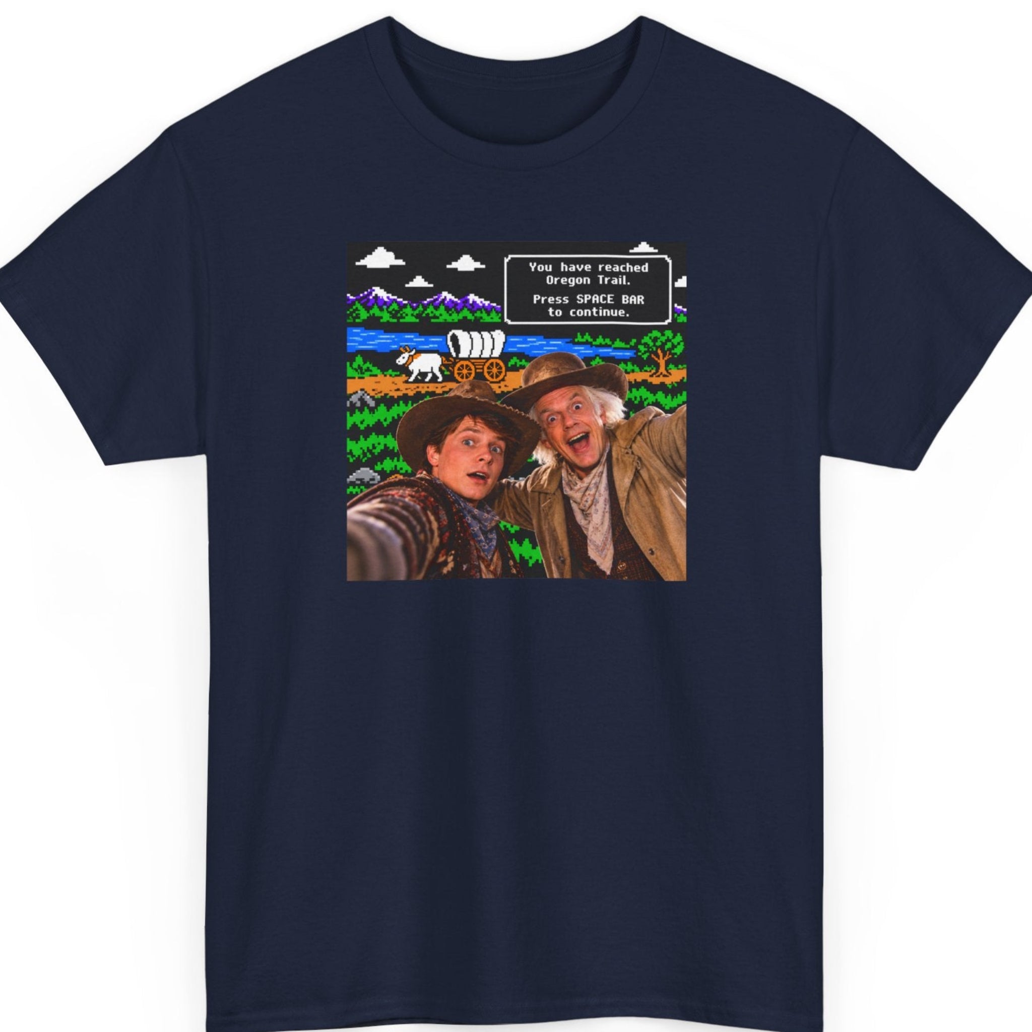 Mayhem Haus Oregon Trail parody navy blue t-shirt featuring two realistic cowboy characters posing for a selfie against an 8-bit video game landscape with mountains, a covered wagon, and a nostalgic computer game message.
