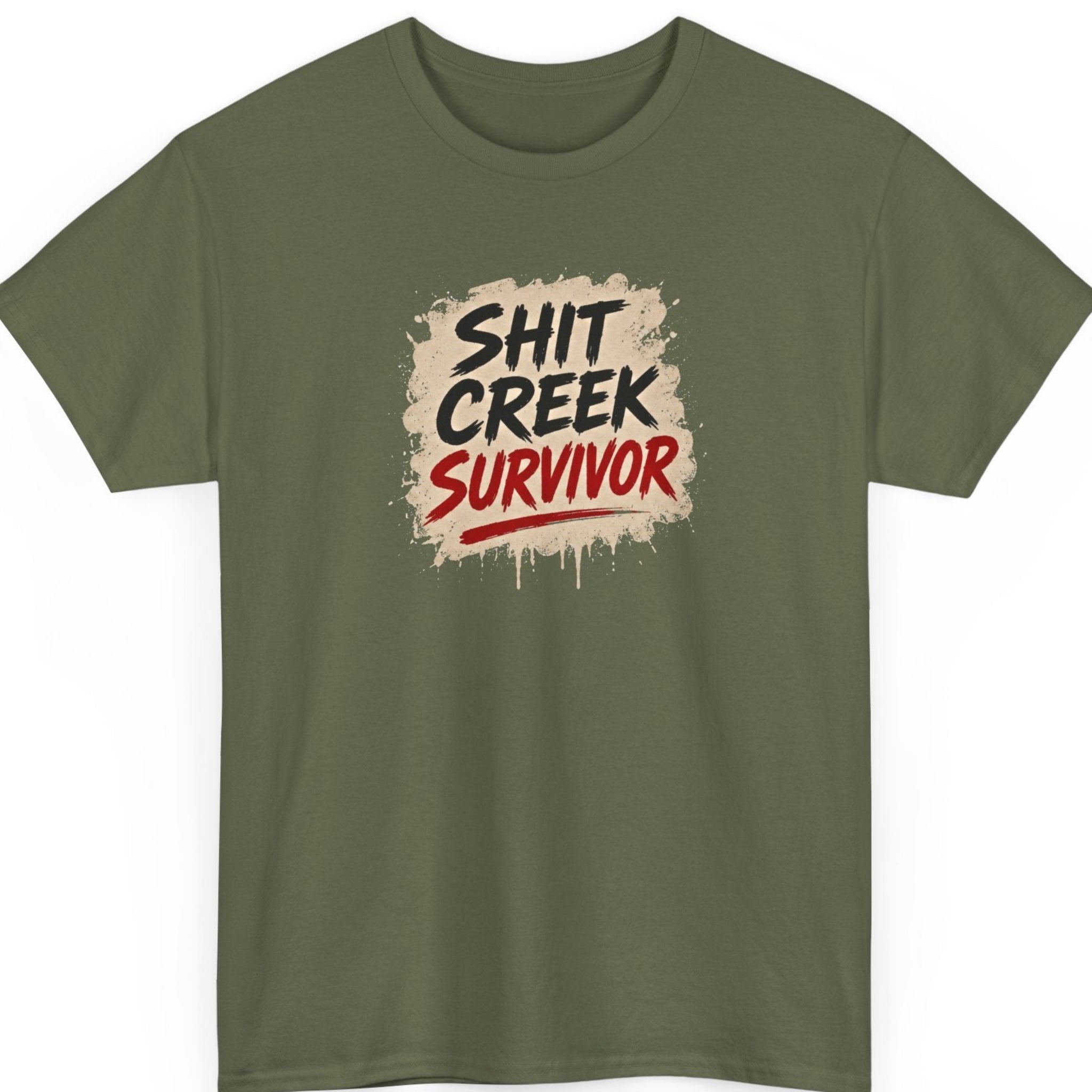 Mayhem Haus grunge statement shirt on a military green tee featuring bold brush-style "Shit Creek Survivor" typography on a distressed paint splatter graphic with dripping accents.