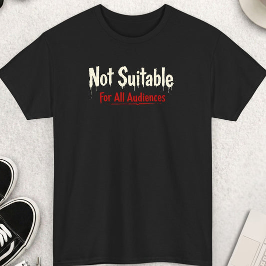 Black t-shirt with 'Not Suitable For All Audiences' text on a light gray surface with shoes, coffee, and accessories.
