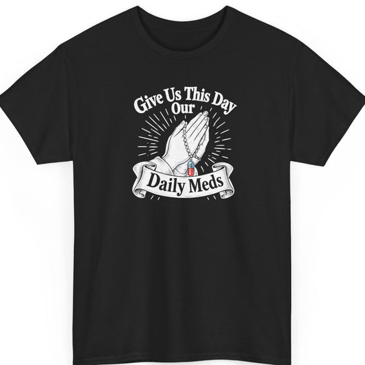 Mayhem Haus “Give Us This Day Our Daily Meds” black t-shirt featuring vintage white praying hands holding a rosary with a red and blue prescription pill, radiating lines, and a decorative ribbon banner.