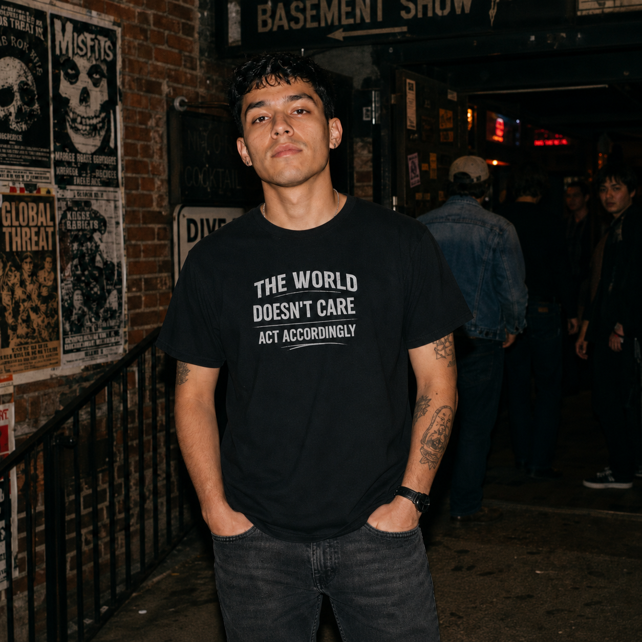 Mayhem Haus The World Doesn't Care T-Shirt on a person with hands in pockets