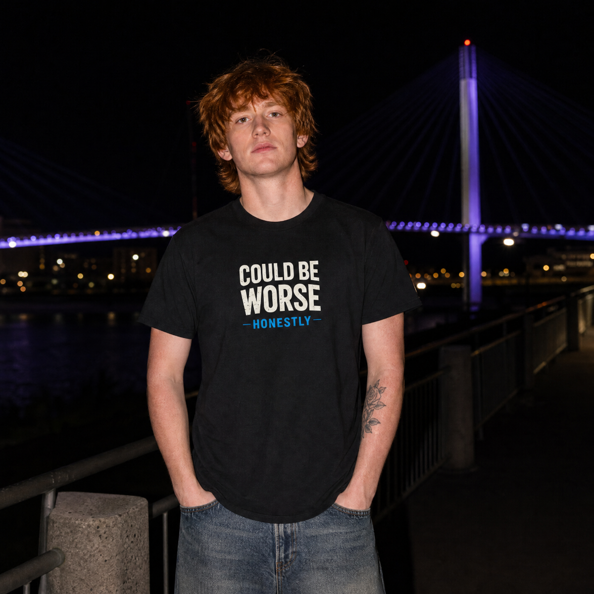 Mayhem Haus Could Be Worse Honestly T-Shirt on a person at night with a bridge in the background