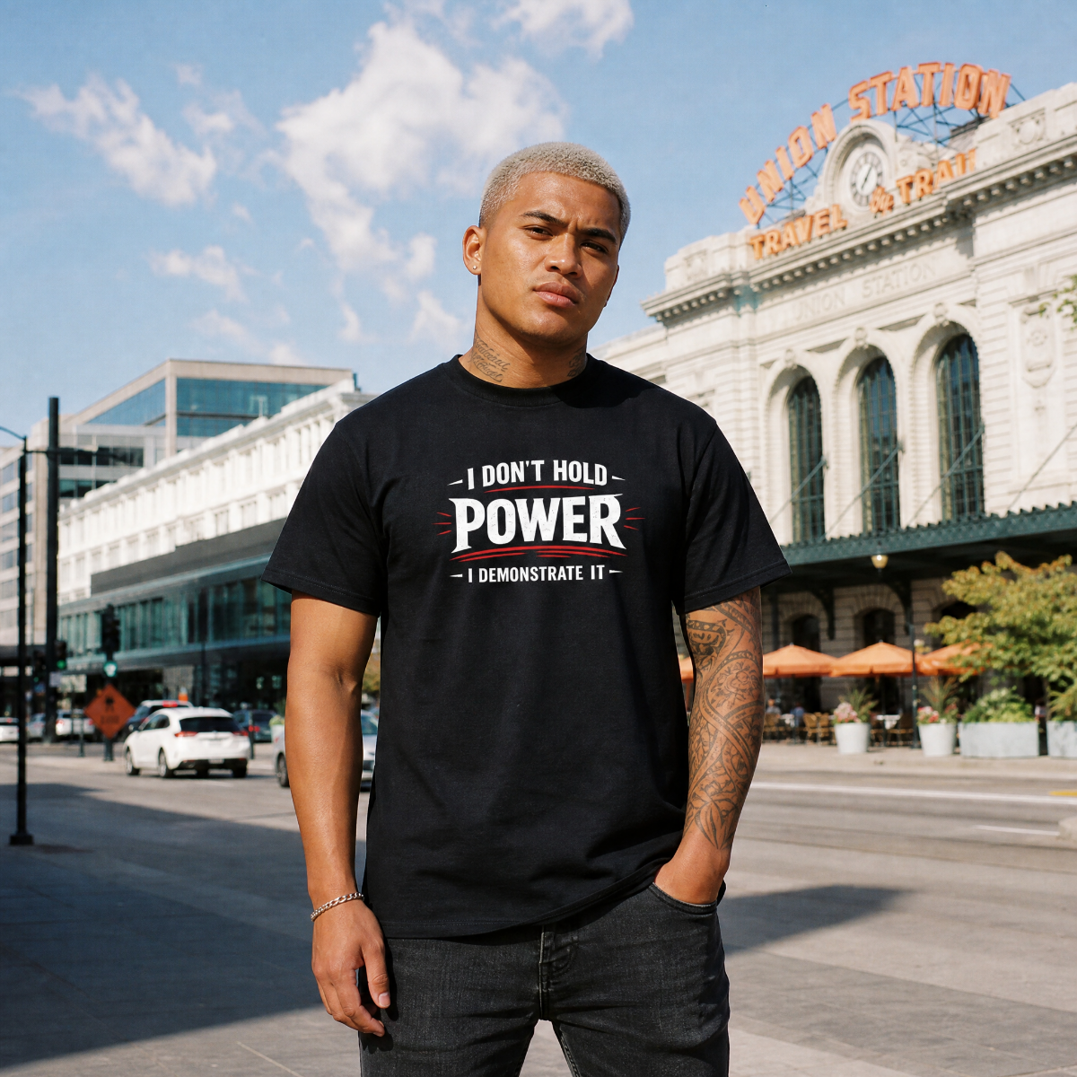 Mayhem Haus I Don’t Hold Power. I Demonstrate It. T-Shirt on a man with blond hair