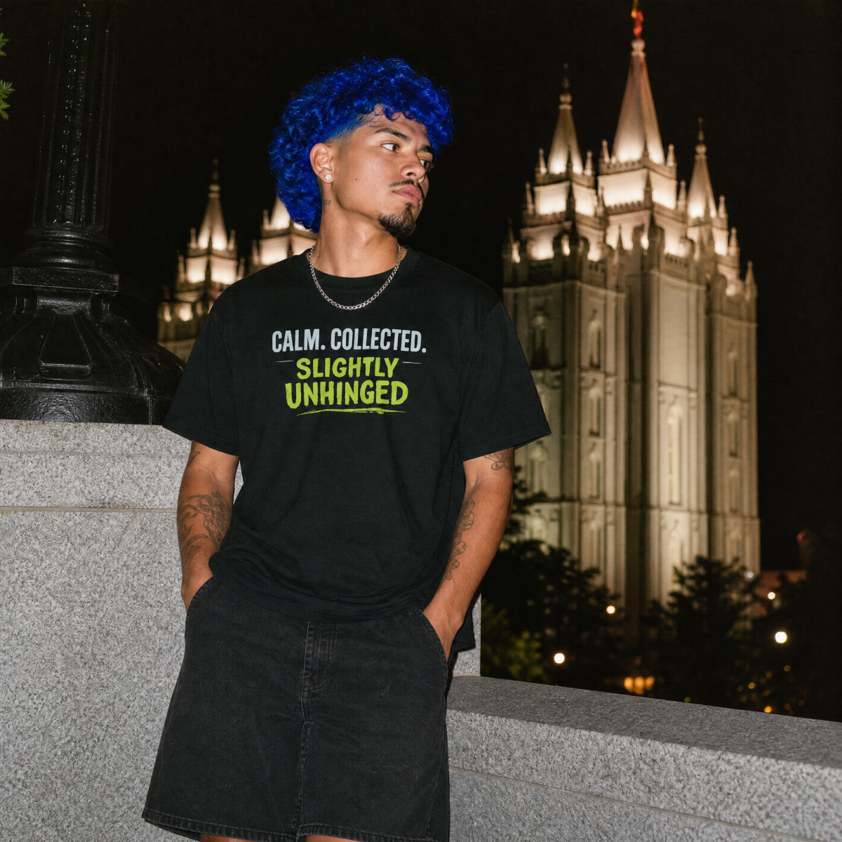 Mayhem Haus Calm, Collected, Slightly Unhinged T-Shirt on a person with blue hair at night